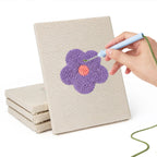 Hand punching one of the Retro Flower Heads mini canvases