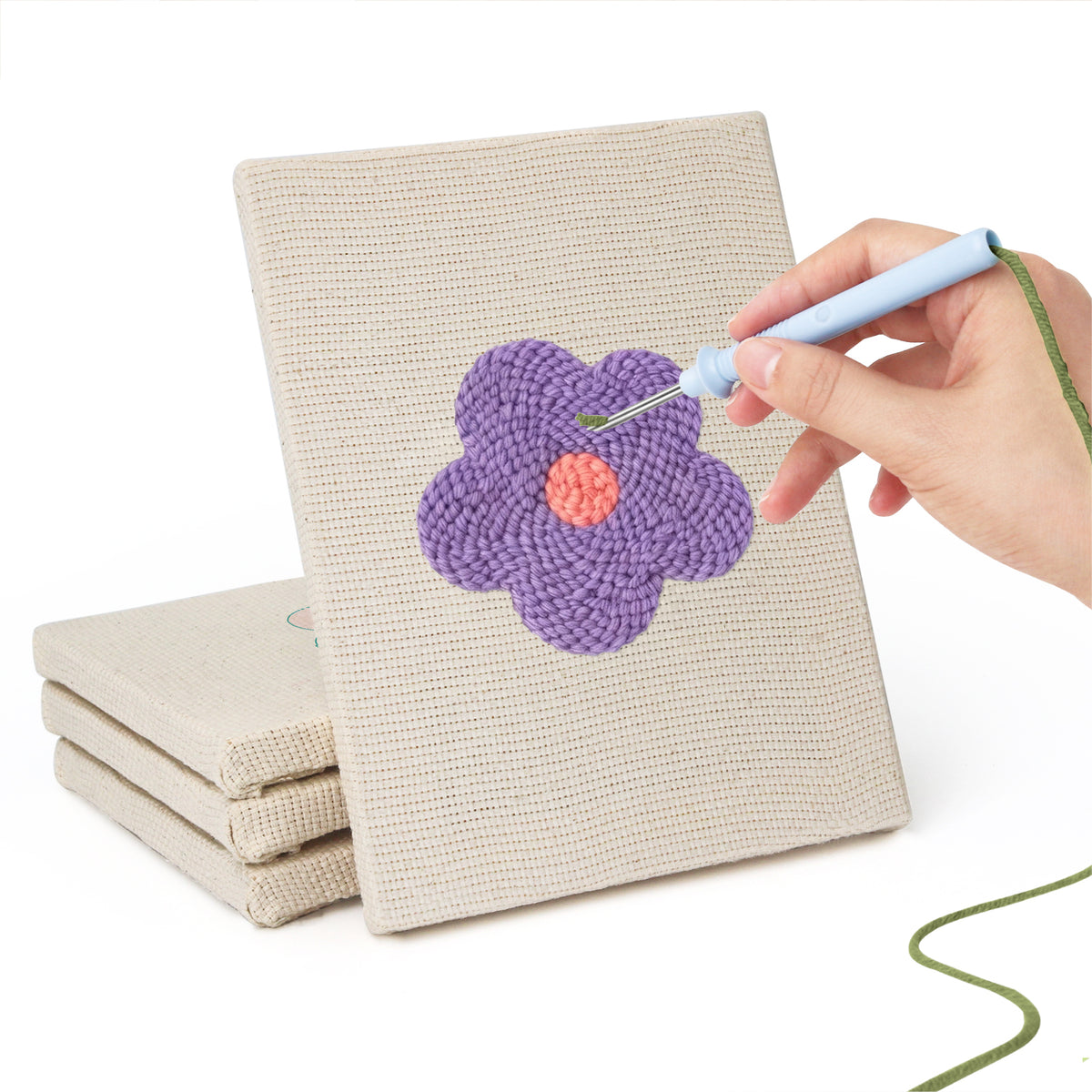 Hand punching one of the Retro Flower Heads mini canvases