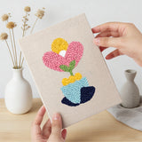 Hand holding a finished Retro Flower Shapes mini canvas
