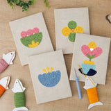 The four finished Retro Flower Shapes mini canvases laid out on a table