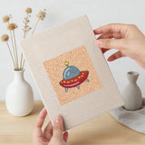 Hand holding a finished Rocket and Saucer mini canvas
