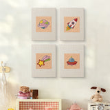 The four Rocket and Saucer mini canvases on a wall above a shelf