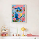 Finished Rosy Blue Owl punch needle canvas on a wall
