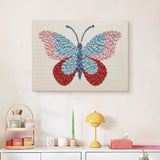 Finished Ruby Wing Butterfly punch needle canvas on a wall