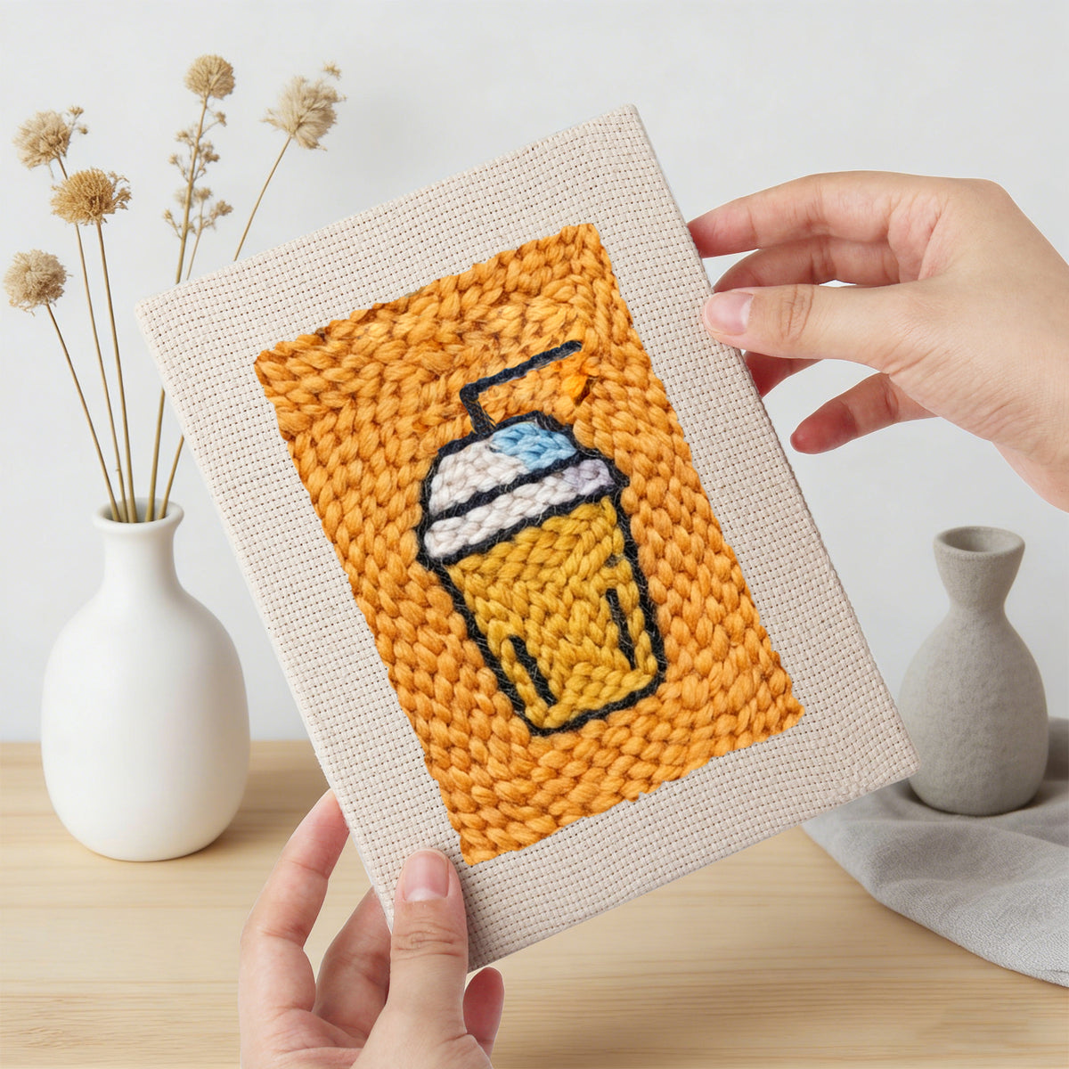 Hand holding a finished Salmon Sushi Lunch mini canvas