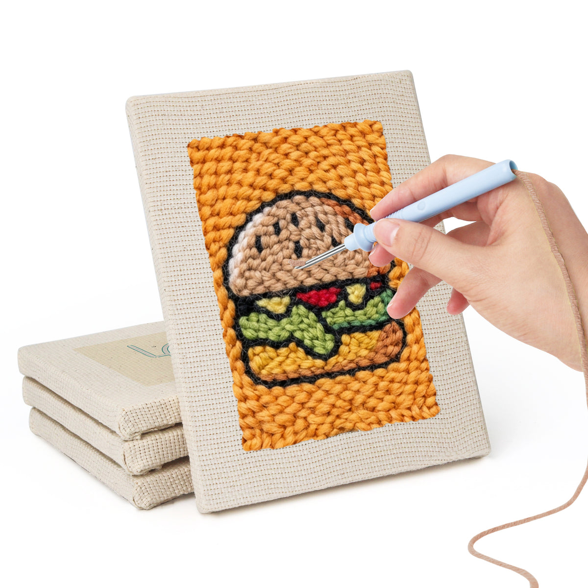 Hand punching one of the Salmon Sushi Lunch mini canvases