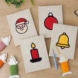The four finished Santa and Candle mini canvases laid out on a table