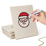 Hand punching one of the Santa and Candle mini canvases