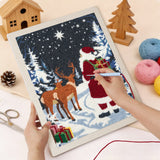 Punching the Santa and Reindeer design with the punch needle