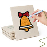 Hand punching one of the Santa and Stocking mini canvases