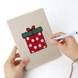 Punching a Santa and Tree mini canvas with the punch needle