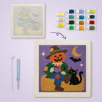 Scarecrow and Cat canvas before and after punching, with the threads and tools