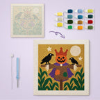 Scarecrow King canvas before and after punching, with the threads and tools