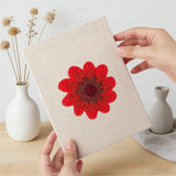 Hand holding a finished Scarlet Flower Heads mini canvas