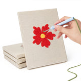 Hand punching one of the Scarlet Flower Heads mini canvases