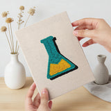 Hand holding a finished Science Class Flask mini canvas