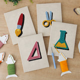 The four finished Science Class Flask mini canvases laid out on a table