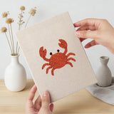 Hand holding a finished Seahorse and Crab mini canvas