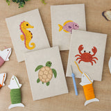 The four finished Seahorse and Crab mini canvases laid out on a table