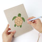 Punching a Seahorse and Crab mini canvas with the punch needle