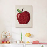 Finished Shiny Red Apple punch needle canvas on a wall