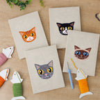 The four finished Siamese and Tuxedo mini canvases laid out on a table