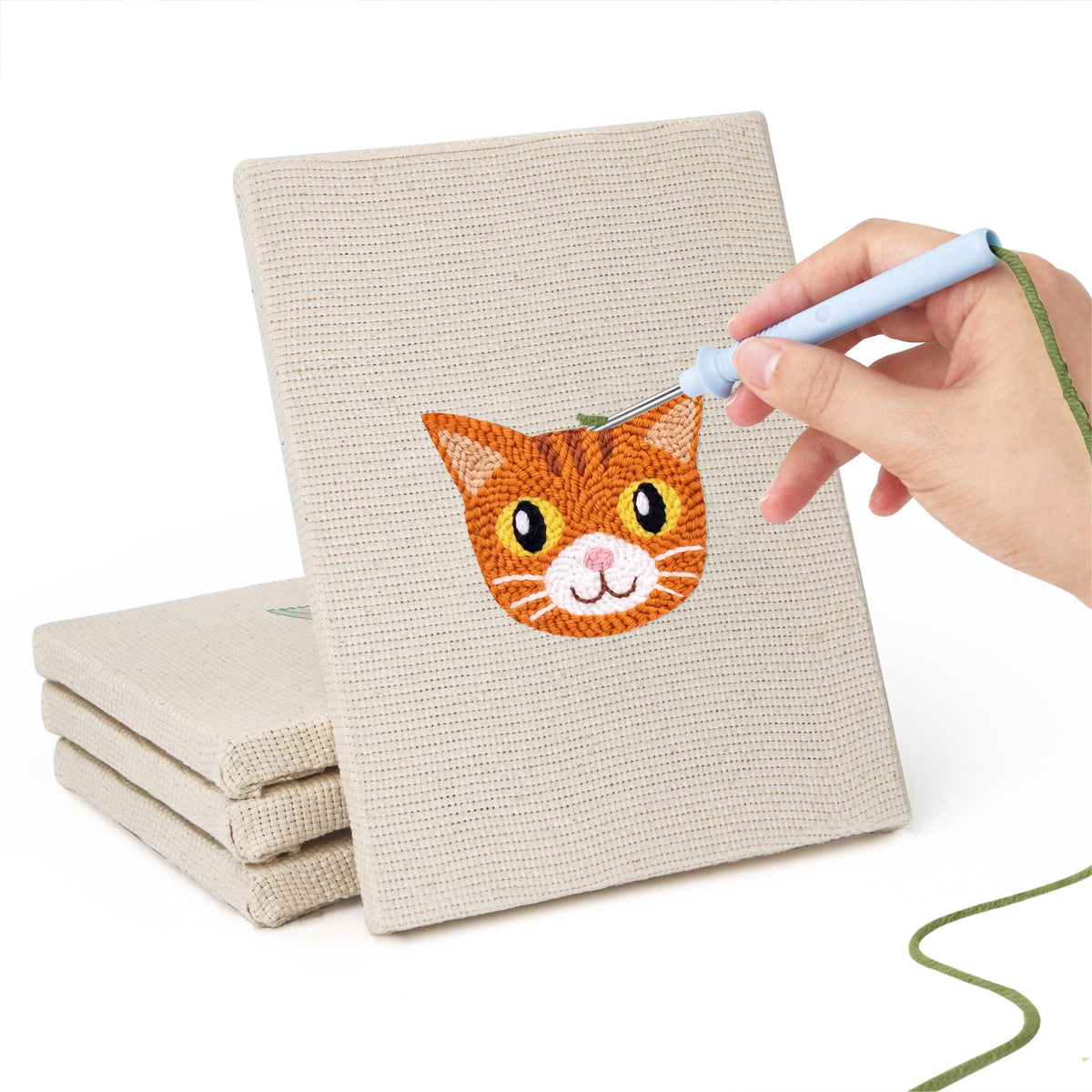 Hand punching one of the Siamese and Tuxedo mini canvases