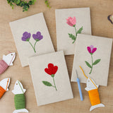 The four finished Single Stem Flowers mini canvases laid out on a table