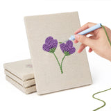 Hand punching one of the Single Stem Flowers mini canvases