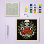 Skeleton Bouquet canvas before and after punching, with the threads and tools