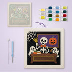 Skeleton Teacher canvas before and after punching, with the threads and tools