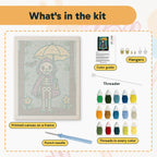 What is in the Skeleton with a Yellow Umbrella kit: printed canvas, punch needle, threader, threads, color guide and hangers