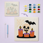 Skull and Candles canvas before and after punching, with the threads and tools