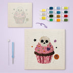 Skull Cupcake canvas before and after punching, with the threads and tools