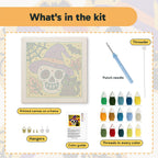 What is in the Skull in a Witch Hat kit: printed canvas, punch needle, threader, threads, color guide and hangers