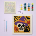 Skull in a Witch Hat canvas before and after punching, with the threads and tools