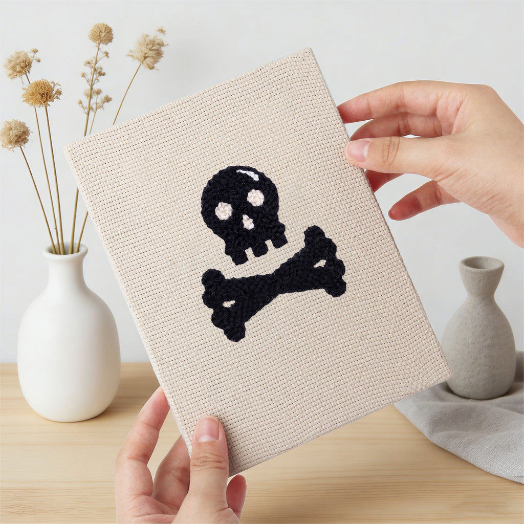 Hand holding a finished Slime and Crossbones mini canvas
