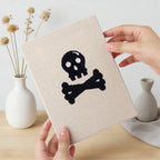 Hand holding a finished Slime and Crossbones mini canvas