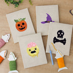 The four finished Slime and Crossbones mini canvases laid out on a table