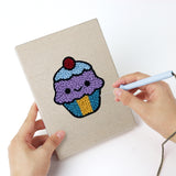 Punching a Smiley Snacks mini canvas with the punch needle