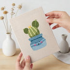 Hand holding a finished Smiling Blue Pots mini canvas