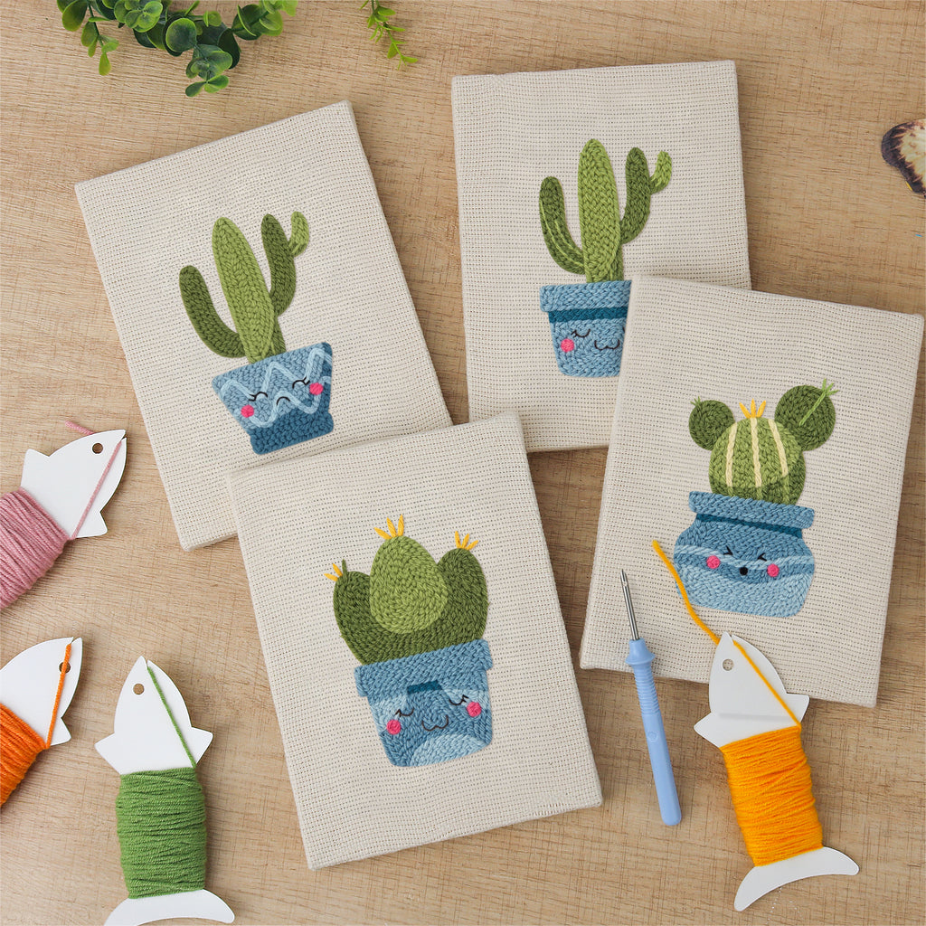 The four finished Smiling Blue Pots mini canvases laid out on a table