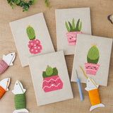 The four finished Smiling Pink Pots mini canvases laid out on a table