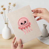 Hand holding a finished Smiling Sea Friends mini canvas