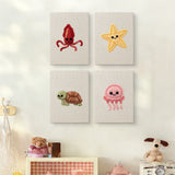 The four Smiling Sea Friends mini canvases on a wall above a shelf