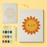 Smiling Sun canvas before and after punching, with the threads and tools
