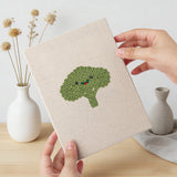 Hand holding a finished Smiling Veggies mini canvas