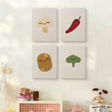 The four Smiling Veggies mini canvases on a wall above a shelf