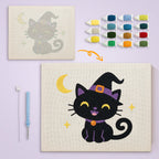 Smiling Witch Kitten canvas before and after punching, with the threads and tools