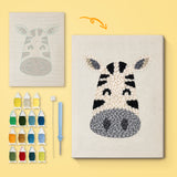 Smiling Zebra canvas before and after punching, with the threads and tools